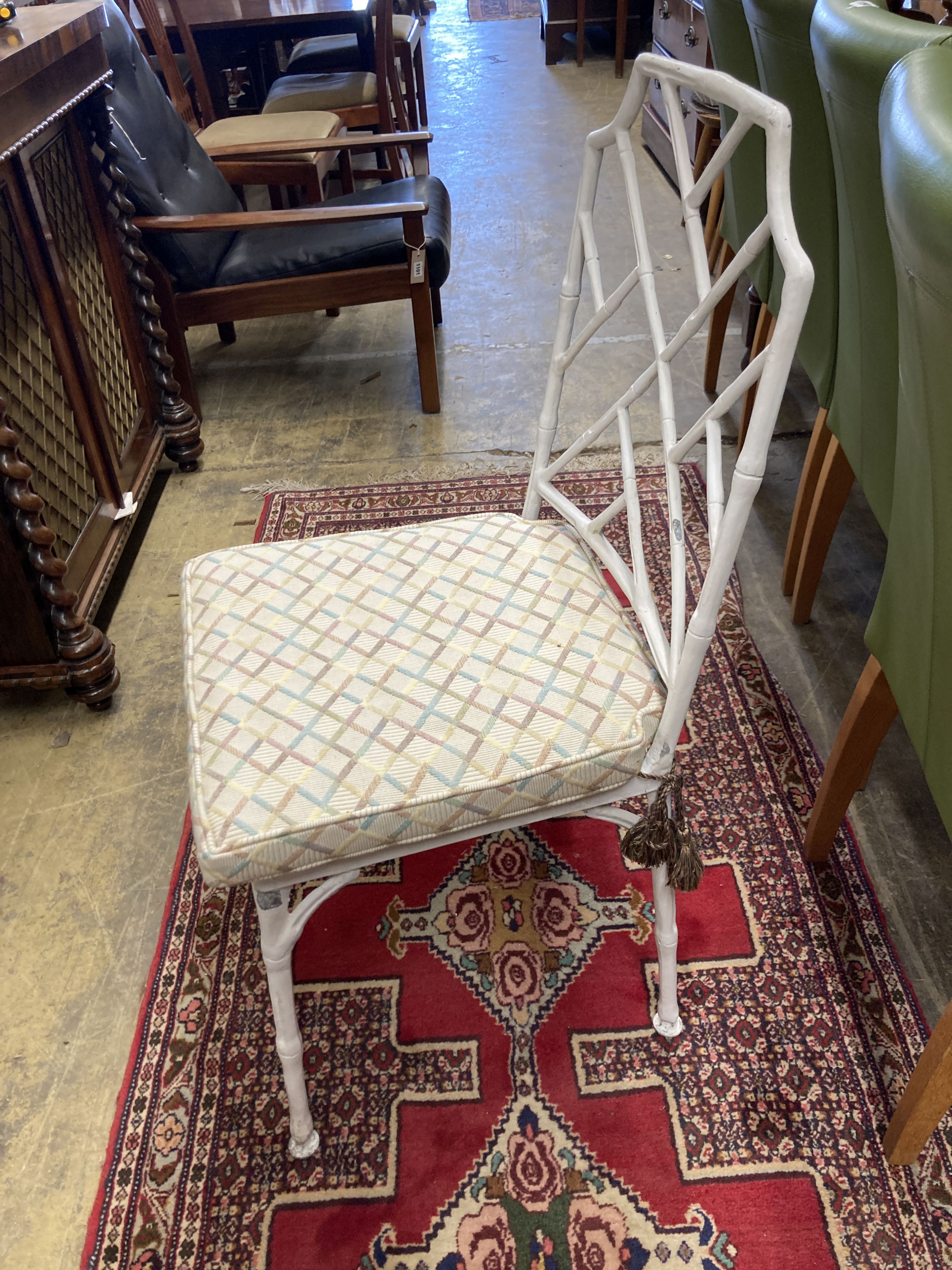 A faux bamboo circular garden table, 98cm diameter, height 72cm together with a set of four painted aluminium faux bamboo garden chairs, two with arms